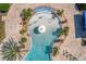 A top-down view of the pool with a splash pad and various lounge chairs at 19407 Sweet Grass Way, Lutz, FL 33558