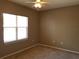 Neutral bedroom with a fan, tan walls, and a bright window for natural light at 2002 E 5Th Ave # 110, Tampa, FL 33605