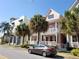 Charming multi-level townhomes with colorful exteriors, balconies, and lush tropical landscaping in a sunny neighborhood at 2002 E 5Th Ave # 110, Tampa, FL 33605