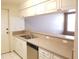 Bright and clean kitchen featuring white cabinets, tiled floor, and a convenient breakfast bar at 2002 E 5Th Ave # 110, Tampa, FL 33605