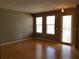 Bright, open-concept living area with wood floors, large windows, and ample natural light at 2002 E 5Th Ave # 110, Tampa, FL 33605