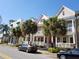 View of residential street with colorful townhomes and tropical landscaping at 2002 E 5Th Ave # 110, Tampa, FL 33605
