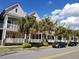 Street view showcasing colorful townhomes with front porches and palm trees at 2002 E 5Th Ave # 110, Tampa, FL 33605