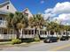 Charming multi-level townhomes with colorful exteriors, balconies, and lush tropical landscaping in a sunny neighborhood at 2002 E 5Th Ave # 110, Tampa, FL 33605