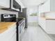 Renovated kitchen featuring stainless steel appliances, white cabinets, and butcher block countertops at 201 W Laurel St # 504B, Tampa, FL 33602