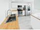 Kitchen with wood countertops, modern appliances, and bright lighting at 201 W Laurel St # 504B, Tampa, FL 33602