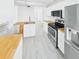 Bright kitchen with stainless steel appliances, butcher block countertops and sleek cabinets at 201 W Laurel St # 504B, Tampa, FL 33602