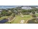 Scenic aerial view of a golf course community showcasing the landscape and proximity to the water at 206 Corbett St, Belleair, FL 33756