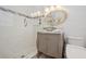 Modern bathroom featuring a glass bowl sink and tiled shower with glass enclosure at 206 Corbett St, Belleair, FL 33756