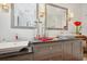 Bathroom with granite counters, modern lighting, and dual mirrors at 206 Corbett St, Belleair, FL 33756