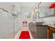 Modern bathroom featuring a tiled shower with glass enclosure and granite counters at 206 Corbett St, Belleair, FL 33756