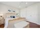 Bedroom featuring a white wicker bed frame, hardwood floors, and natural lighting at 206 Corbett St, Belleair, FL 33756