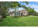 Beautiful home with tropical landscaping, offering a glimpse of its facade and well-maintained surroundings at 206 Corbett St, Belleair, FL 33756