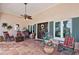 Charming front porch with rocking chairs and tiled flooring, showcasing a welcoming entrance to the home at 206 Corbett St, Belleair, FL 33756