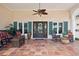 Welcoming front porch with tiled flooring, rocking chairs, and a decorative door, creating a cozy outdoor space at 206 Corbett St, Belleair, FL 33756