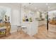 Bright kitchen with white countertops, stainless steel appliances, and barstool seating at 206 Corbett St, Belleair, FL 33756