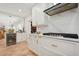 Bright kitchen features marble countertops, white cabinets, and a gas stove at 206 Corbett St, Belleair, FL 33756