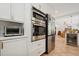 Modern kitchen with built-in appliances and a bar overlooking the dining room at 206 Corbett St, Belleair, FL 33756