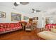 Bright living room with hardwood floors, unique furnishings, and neutral wall colors at 206 Corbett St, Belleair, FL 33756