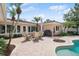 Covered patio with dining set next to a beautiful pool and outdoor living space at 206 Corbett St, Belleair, FL 33756