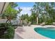 Private pool area with lush greenery and patio seating, ideal for relaxation at 206 Corbett St, Belleair, FL 33756