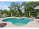Resort-style pool area surrounded by lush landscaping and patio furniture at 206 Corbett St, Belleair, FL 33756