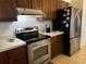 Efficient kitchen featuring stainless steel appliances, wooden cabinets, and tile floors at 2154 Briarway Dr, Clearwater, FL 33763