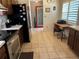 Functional kitchen area with stainless steel appliances, wood cabinetry, and tiled floor at 2154 Briarway Dr, Clearwater, FL 33763