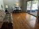 Cozy living room featuring hardwood floors, a dining area, and sliding glass doors at 2154 Briarway Dr, Clearwater, FL 33763