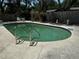 Refreshing backyard pool surrounded by a concrete deck and mature landscaping at 2154 Briarway Dr, Clearwater, FL 33763