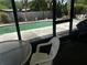 Relaxing screened lanai offering views of the backyard pool and tropical greenery at 2154 Briarway Dr, Clearwater, FL 33763