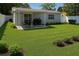 Well-maintained backyard with lush lawn, patio area, and white fencing offers a serene outdoor space at 2205 N Grady Ave, Tampa, FL 33607