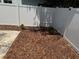 Backyard area showcases fresh mulch and a white privacy fence, enhancing the property's appeal at 2205 N Grady Ave, Tampa, FL 33607