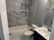 Updated bathroom features a shower-over-tub with tiled surround and built-in shelving, plus a modern vanity at 2205 N Grady Ave, Tampa, FL 33607