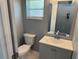 Updated powder room with a sleek vanity, modern faucet, and a square framed mirror at 2205 N Grady Ave, Tampa, FL 33607