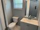 Updated powder room with a sleek vanity, modern faucet, and a square framed mirror at 2205 N Grady Ave, Tampa, FL 33607