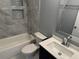 Updated bathroom features a shower-over-tub with tiled surround and built-in shelving, plus a modern vanity at 2205 N Grady Ave, Tampa, FL 33607