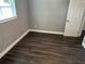 A bright bedroom features hardwood floors and neutral paint, awaiting personalization at 2205 N Grady Ave, Tampa, FL 33607
