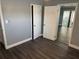 Bedroom featuring wood-look floors, gray paint, and natural light at 2205 N Grady Ave, Tampa, FL 33607