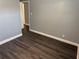 A bright bedroom features hardwood floors and neutral paint, awaiting personalization at 2205 N Grady Ave, Tampa, FL 33607