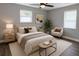 Stylized bedroom with neutral tones, a large bed, area rug, and natural light creates a calming space at 2205 N Grady Ave, Tampa, FL 33607