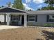 Charming single-story home with an inviting covered entrance and freshly mulched landscaping at 2205 N Grady Ave, Tampa, FL 33607