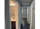 Hallway featuring wood-look floors, gray paint, and views of the updated bathroom at 2205 N Grady Ave, Tampa, FL 33607