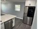 Updated kitchen with white cabinets, stainless steel appliances, and a large refrigerator at 2205 N Grady Ave, Tampa, FL 33607