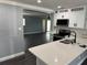Modern kitchen showcasing white cabinets, stainless appliances, granite counters, and open layout to living spaces at 2205 N Grady Ave, Tampa, FL 33607
