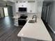 Modern kitchen with white cabinetry, sleek appliances, and a spacious countertop at 2205 N Grady Ave, Tampa, FL 33607