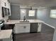 Updated kitchen with white cabinets, black hardware and stainless steel appliances at 2205 N Grady Ave, Tampa, FL 33607