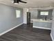 Open floor plan showing updated kitchen with stainless steel appliances and gray tone walls at 2205 N Grady Ave, Tampa, FL 33607