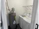 Convenient laundry room with updated washer and dryer, water heater, and ample space at 2205 N Grady Ave, Tampa, FL 33607