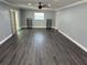 Spacious open-concept living area featuring wood-look floors, neutral paint, and natural light at 2205 N Grady Ave, Tampa, FL 33607